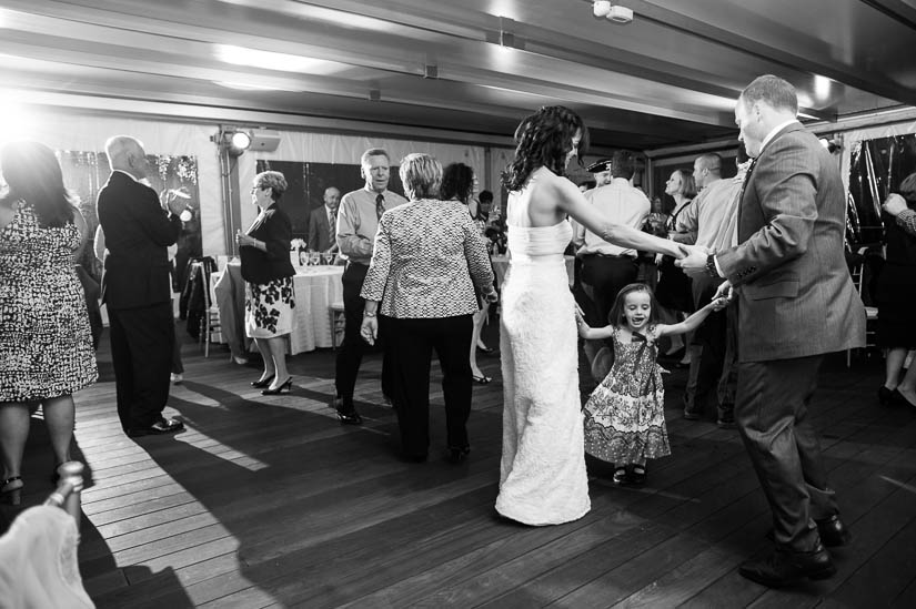 dancing with a little girl at flying bridge wedding