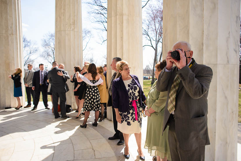 father of the groom taking pictures at the wedding