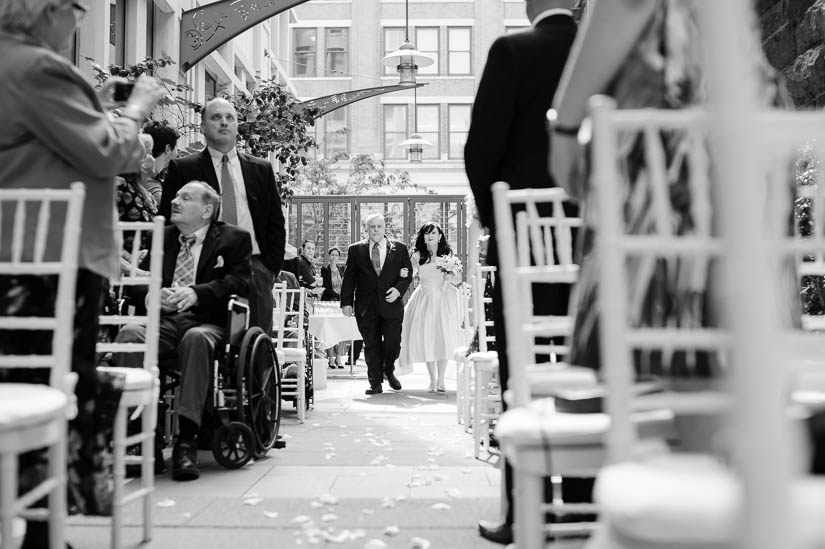 bride walks down the aisle with her father at co co sala wedding