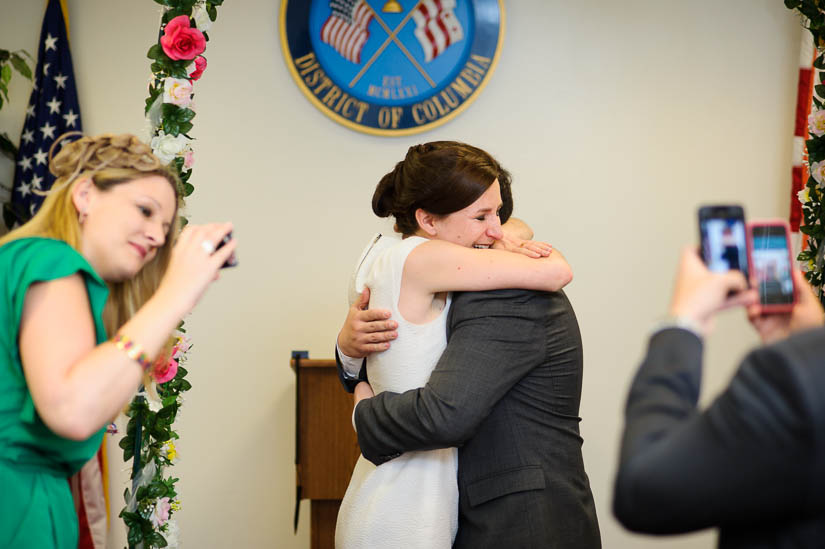 hugging at the end of the dc courthouse wedding ceremony
