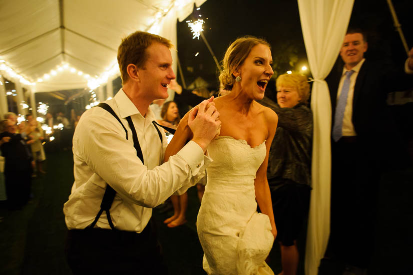 bride and groom running through sparklers at green spring valley hunt club wedding