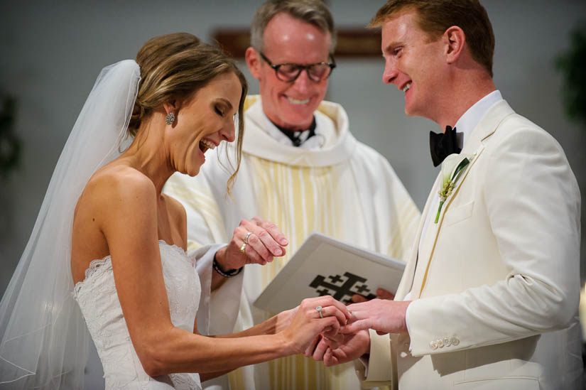 putting on the rings during catholic wedding ceremony at Loyola Blakefield church