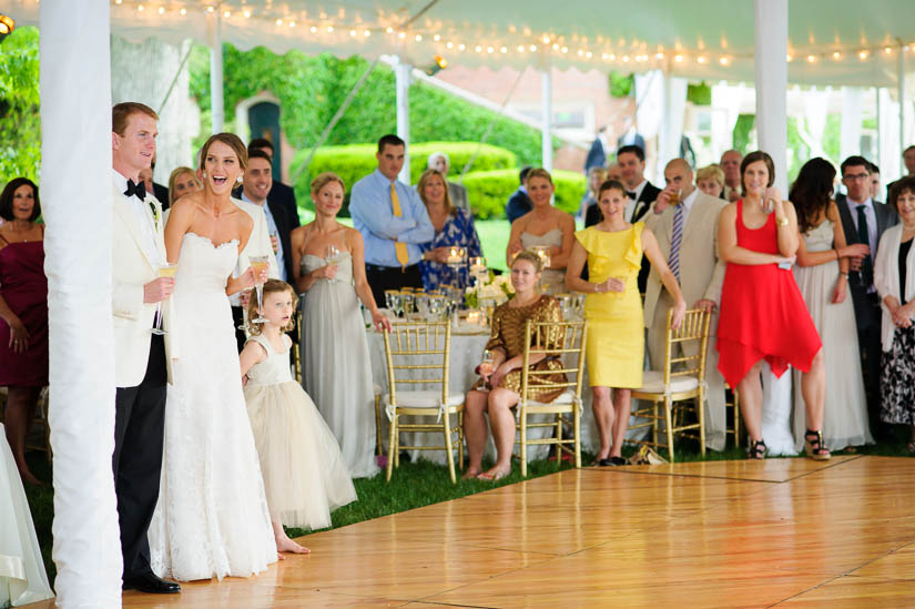 bride and groom laughing during wedding speeches