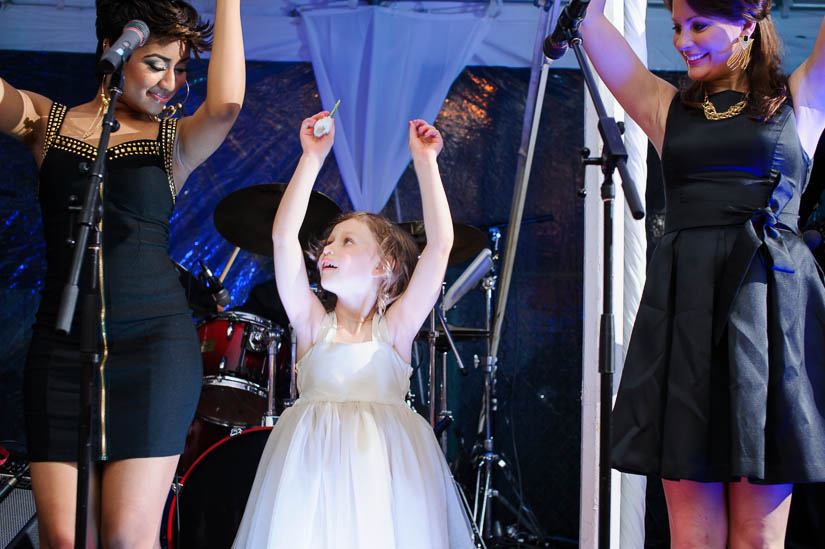 little girl on stage with escapade at a wedding