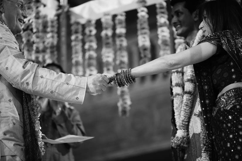 father and daughter holding hands during wedding ceremony