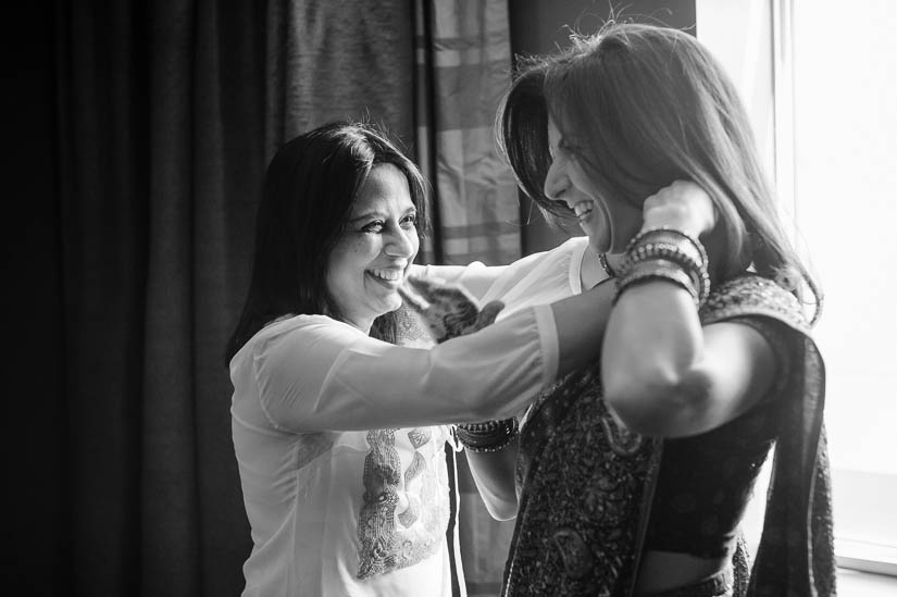 bride's auntie helps her get ready