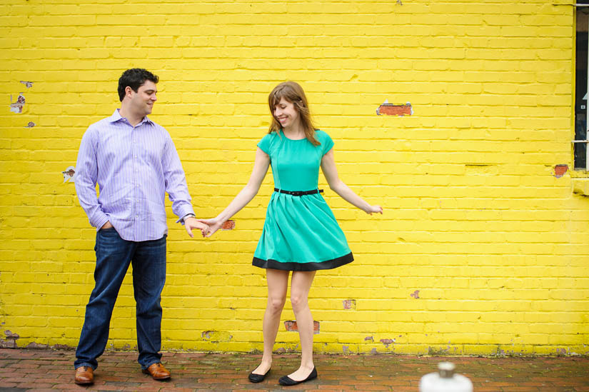 engagement photos at the yellow wall in old town alexandria