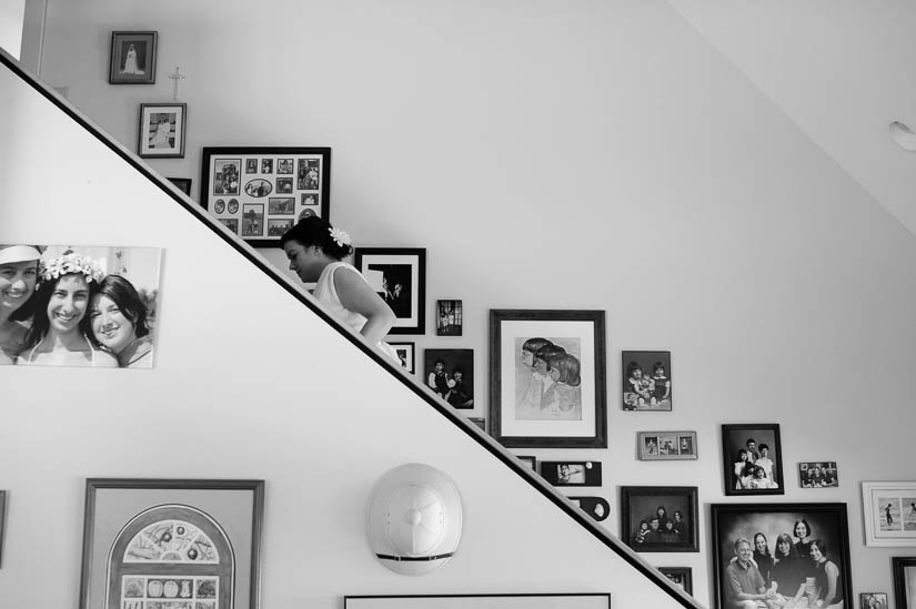 bride walks up the stairs in a family home