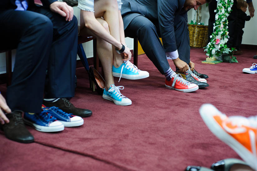 putting on colored converse at dc courthouse wedding
