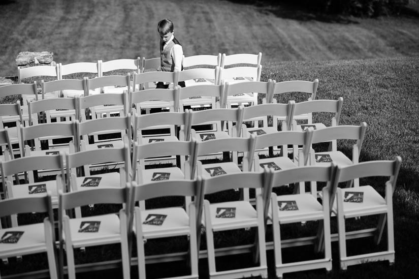 little boy sets up programs at historic rosemont manor wedding