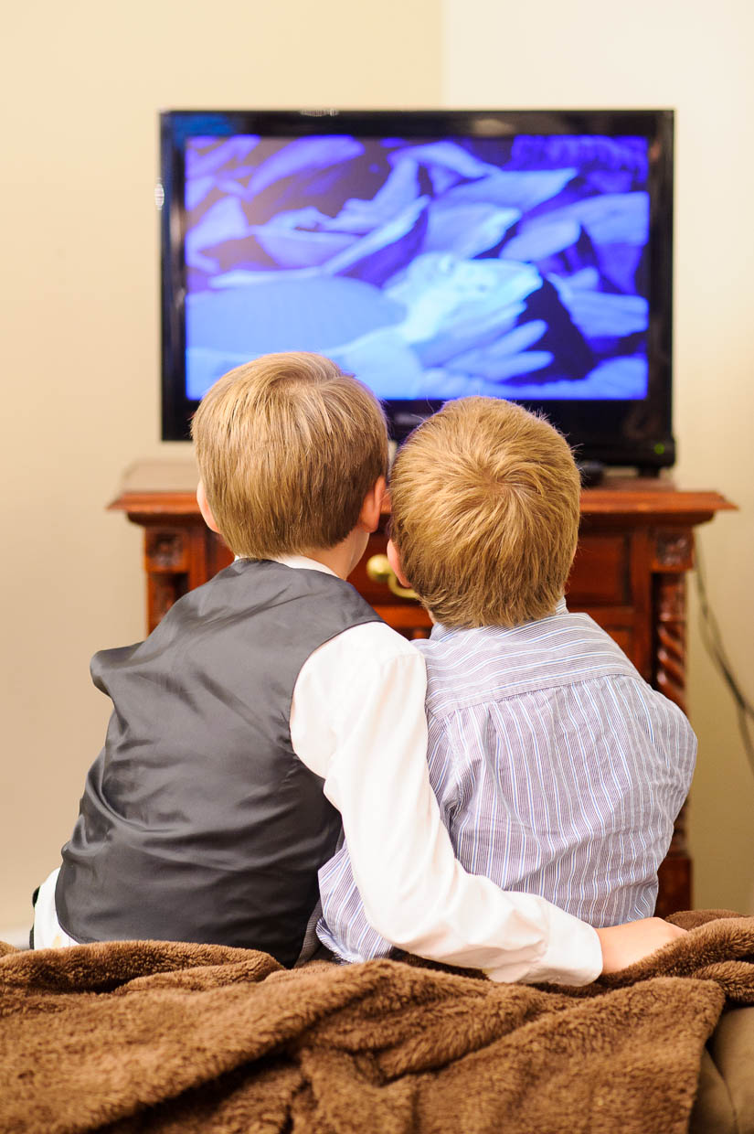 little boys watching tv during the wedding