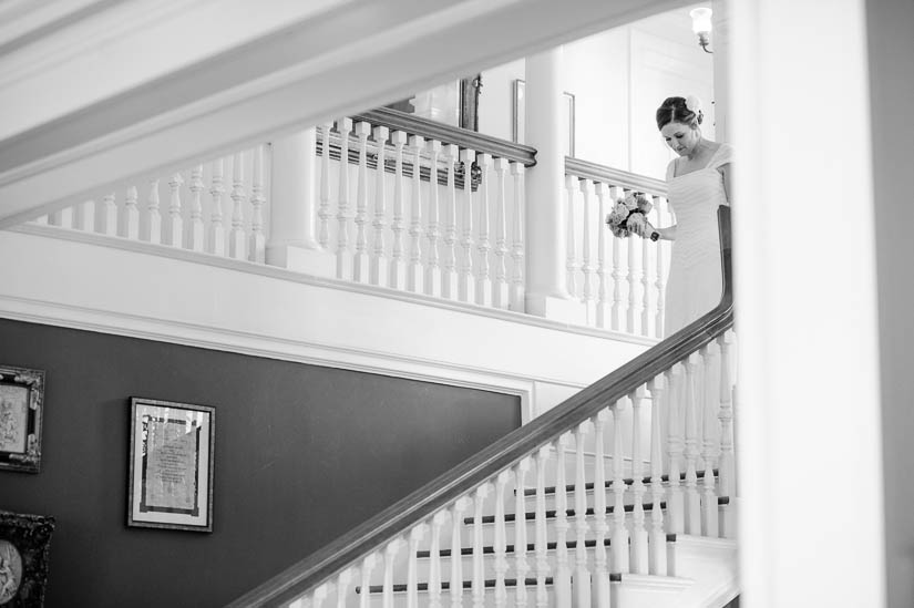 bride coming down the stairs at historic rosemont manor wedding