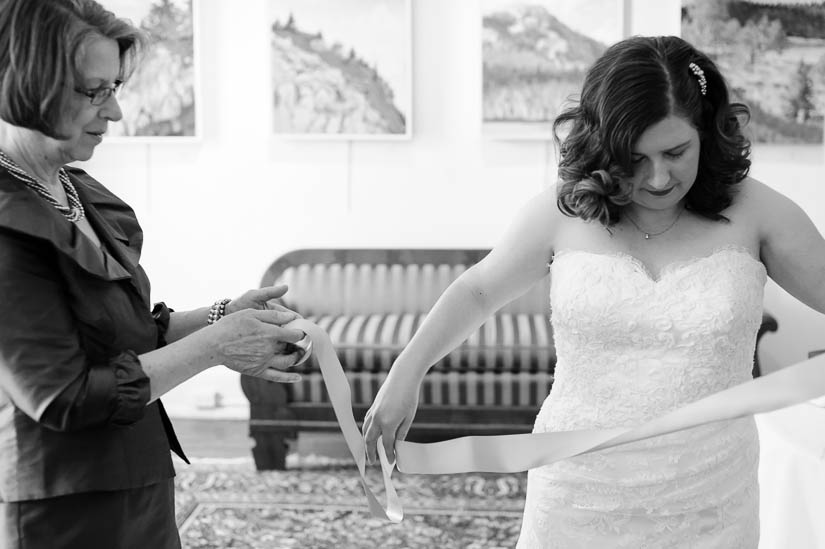 bride preparing her sash before the wedding