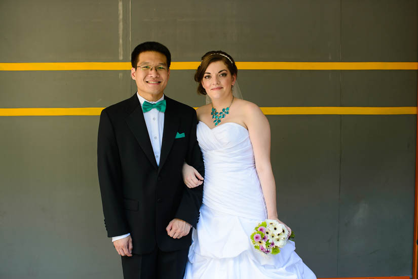 wedding portraits in front of a parking garage door