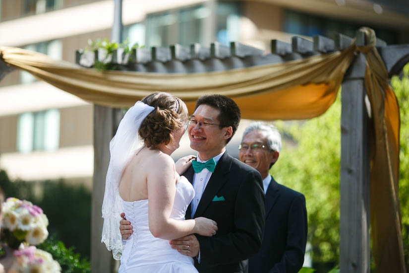 bride and groom during the ceremony at Crowne Plaza Crystal City wedding