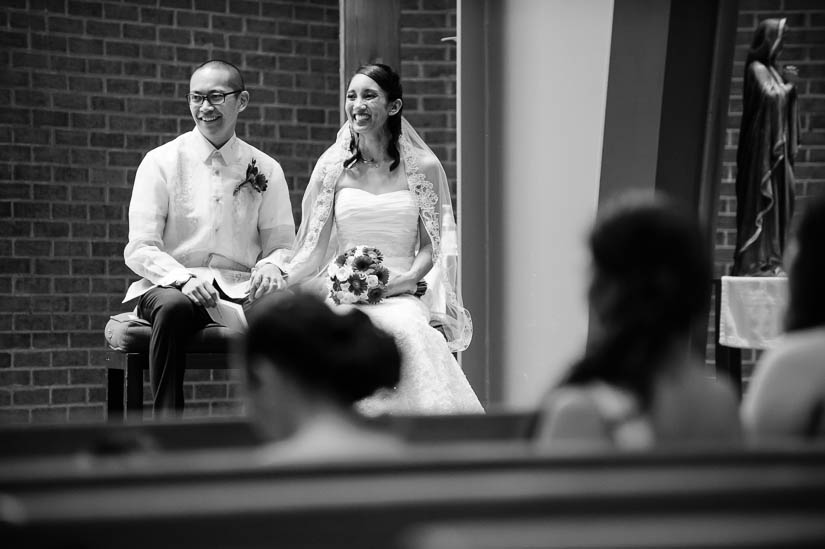 bride and groom laughing at the altar