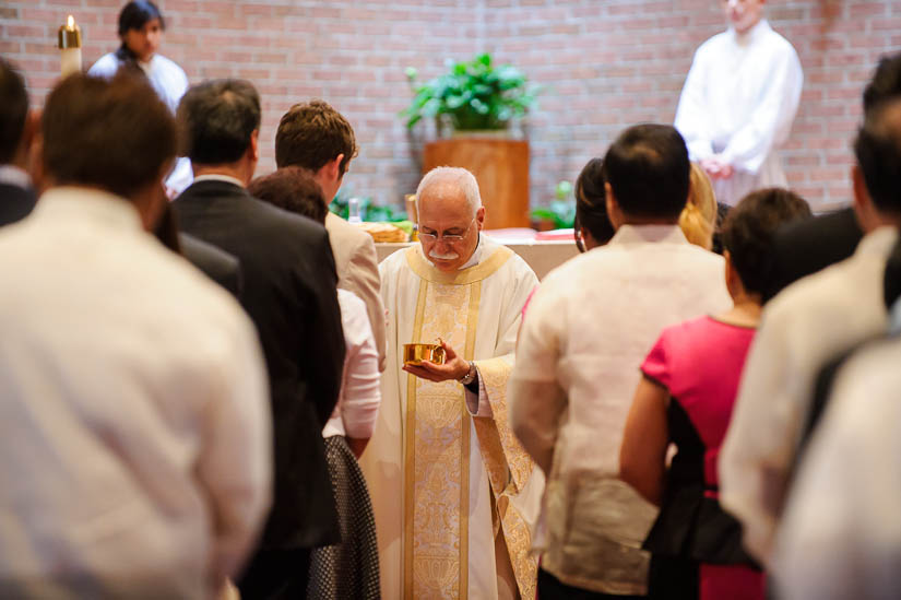 priest giving mass during wedding ceremony
