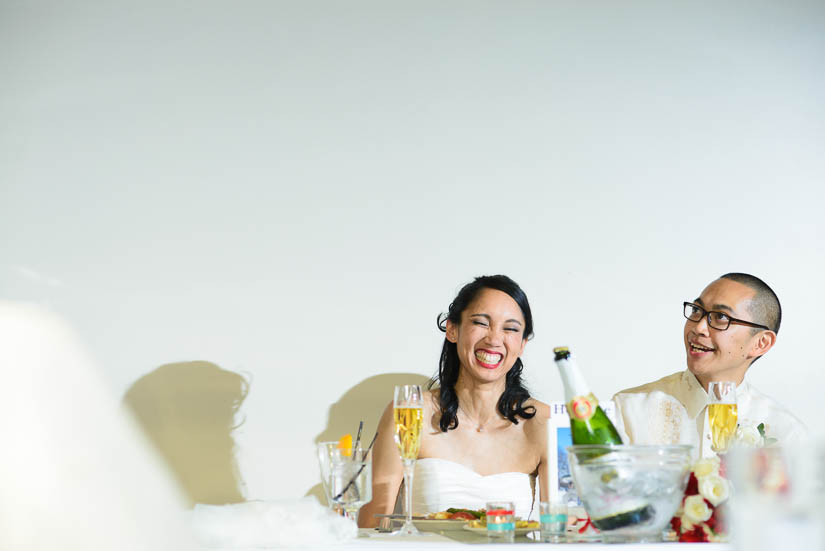 bride and groom laughing during speeches