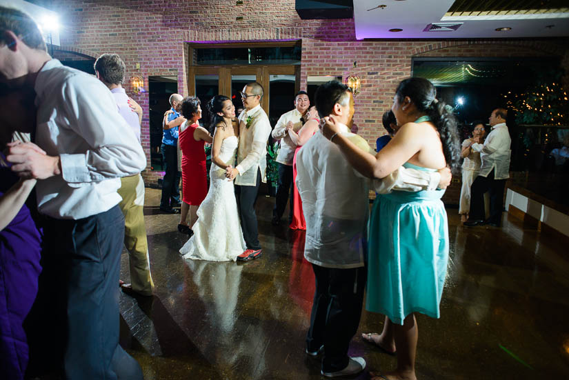 bride and groom dancing in the crowd at the wedding reception