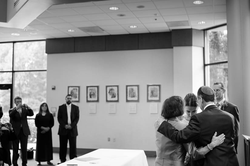 bride with her parents before signing the ketubah