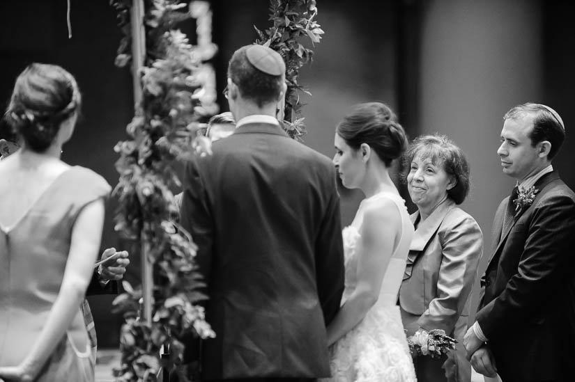 mother looking at her daughter during jewish wedding ceremony