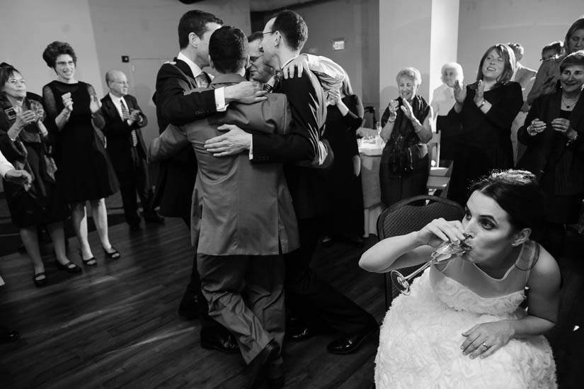 bride downing champagne during klezmer dancing