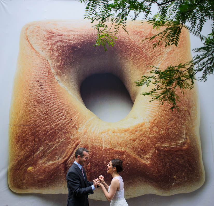 wedding portrait in front of a giant bagel