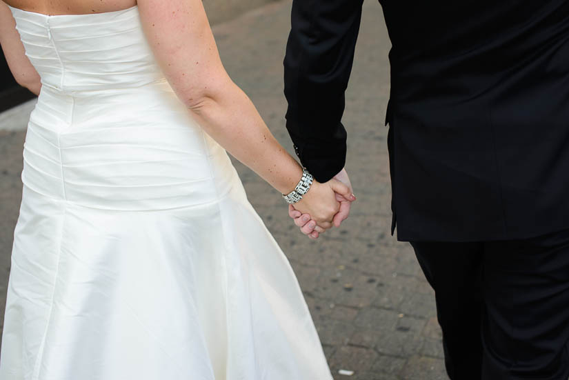 bride and groom holding hands in arlington, va