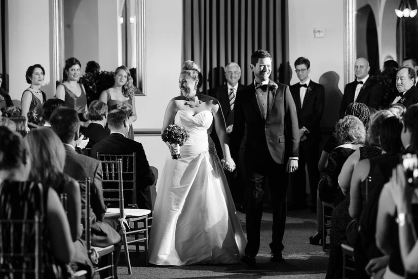 bride and groom walking away from the wedding ceremony