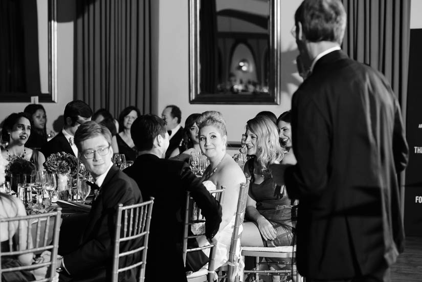 bride watches her father give a toast at the reception
