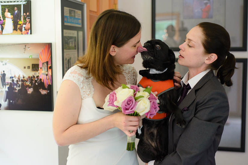 taking pictures with their dog during the wedding