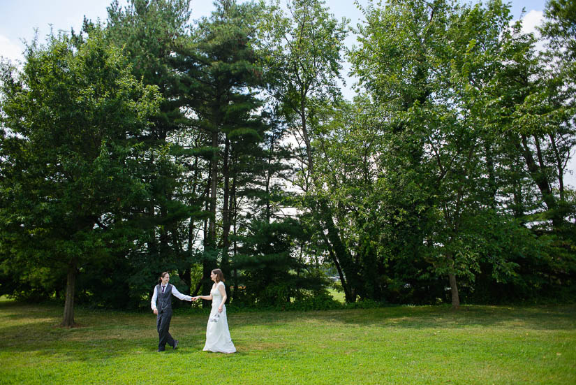 walking in a field during wedding portraits