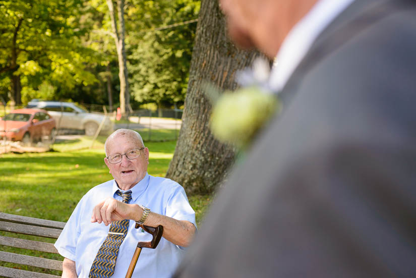grandfather talking to father of the bride at pfi