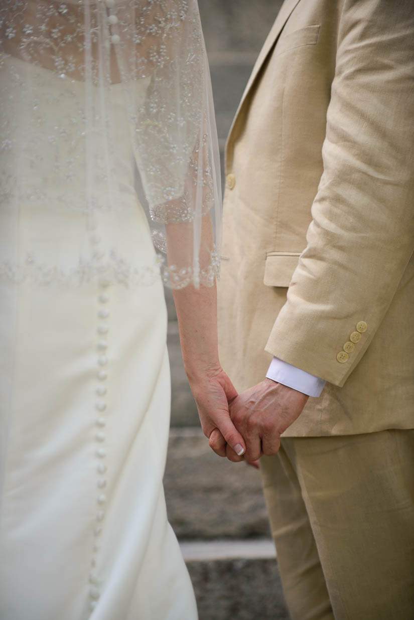 bride and groom holding hands during wedding ceremony