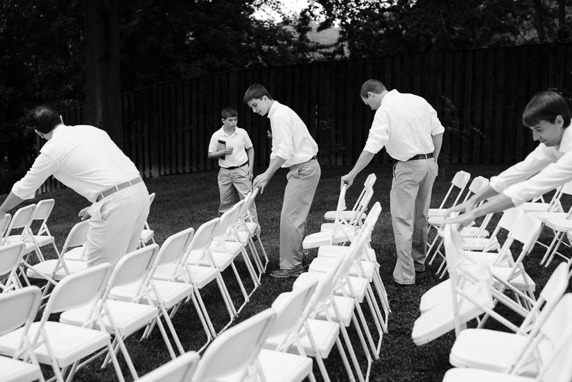 groomsmen drying off chairs at the woodlands at algonkian wedding