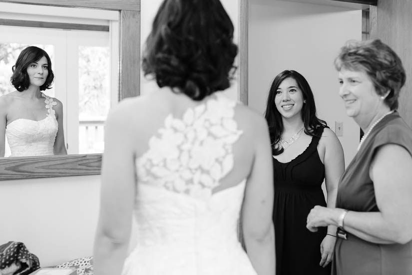 bride's mother and friend help her get ready