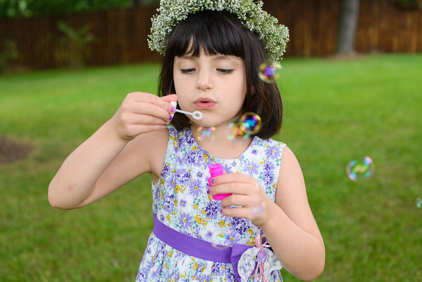 flower girl blowing bubbles at the woodlands at algonkian