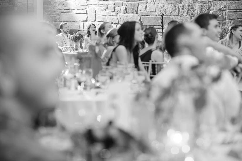 bride and groom laughing across the room