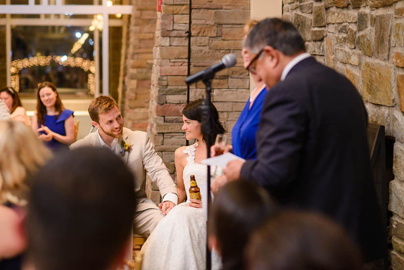 bride and groom during parent speeches
