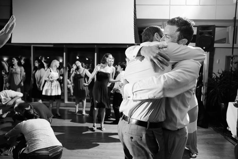 groom hugging his brother at the woodlands at algonkian