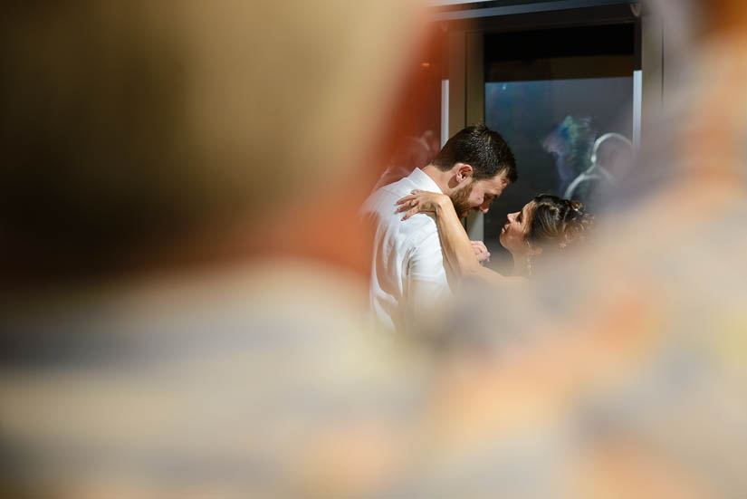 groom and his mother dance with father in foreground at the woodlands at algonkian wedding