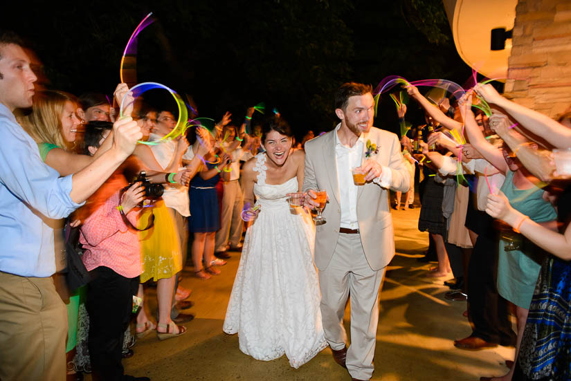 bride and groom exit with glow sticks