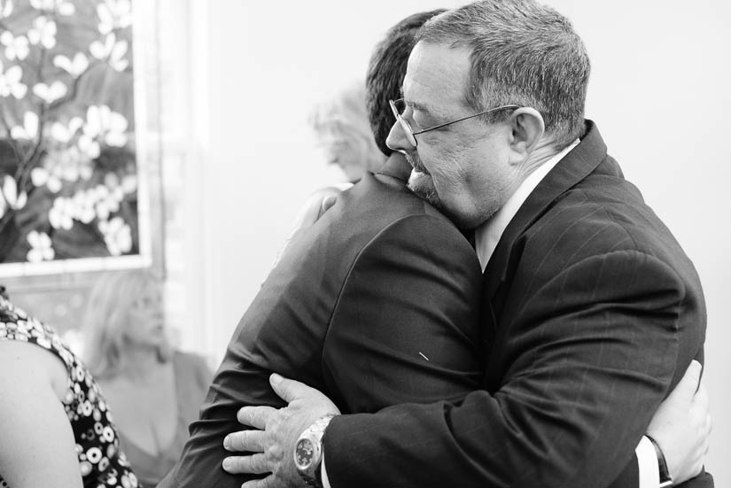 father hugs his son at washington dc wedding