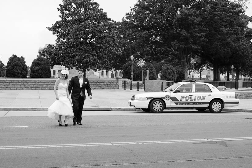 bride and groom crossing the street between the capitol and library of congress